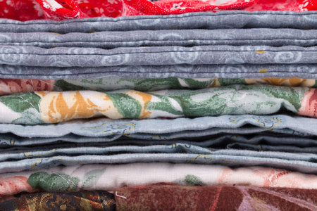Stack of color clothes stored in rows. Whole background.