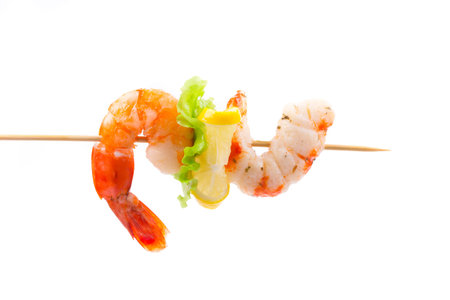 Grilled shrimps on a stick. Isolated on a white background.の写真素材
