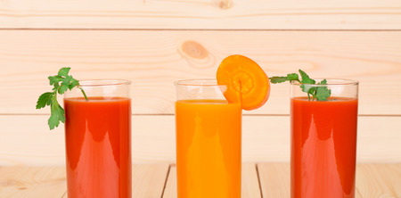 Two juices of tomato and carrot. Whole background.の写真素材