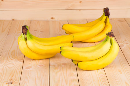 Close up of fresh bananas on wood.の写真素材