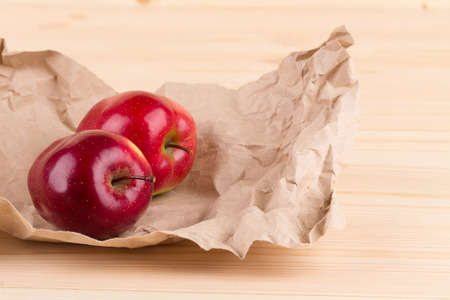 Close up of ripe red apples on wood.の写真素材