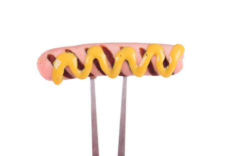 Grilled sausage on a fork. Isolated on a white background.の写真素材