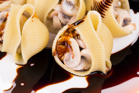 Lumaconi pasta with mushroom sauce. Whole background.の写真素材