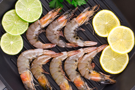 Fresh shrimps with lemon and parsley. Whole background.の写真素材