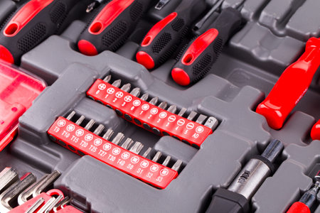 Drill bit set in box close up. Red and gray color.