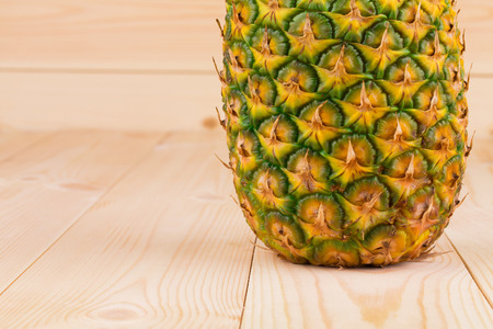 Half of Fresh ripe pineapple on the wooden background.の写真素材