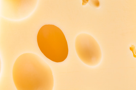 Background of fresh Swiss cheese in closeupの写真素材