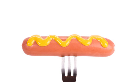 Grilled sausage on a fork. Isolated on a white background.の写真素材