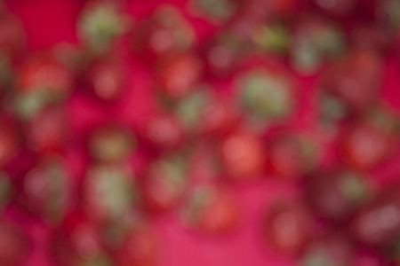 Blurred red background with green spots. Abstract.の写真素材