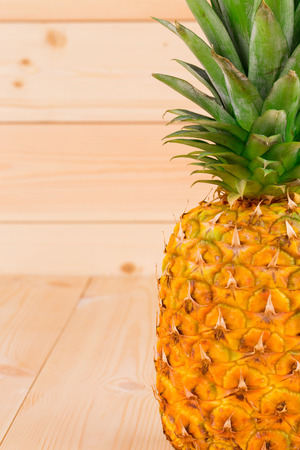Fresh ripe pineapple on the wooden background.の写真素材