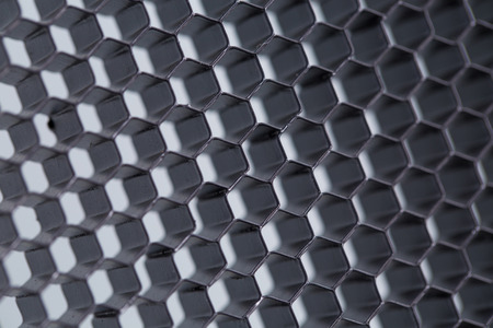 Honeycomb grid against grey background close upの写真素材