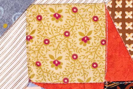 beautiful handmade quilts in closeup as background