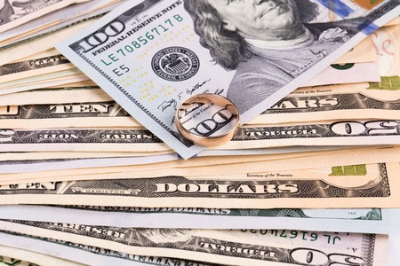 Close up of different dollar bills with golden ring. Whole background.の写真素材