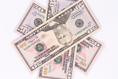 Close up of different dollar bills. Isolated on a white background.