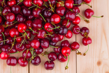 Fresh cherries on wooden table in the closeup. Whole background.の写真素材