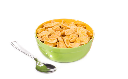 Bowl of corn flakes with spoon. Isolated on a white background.の写真素材
