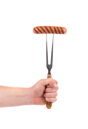 Grilled sausage on a fork. Isolated on a white background.の写真素材