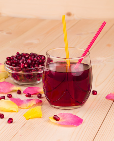 Pomegranate juice in a glass and ripe pomegranate grains.の写真素材