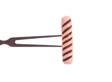 Grilled sausage on a fork. Isolated on a white background.の写真素材