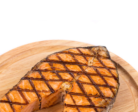 Grilled salmon steak on platter. Whole background.の写真素材