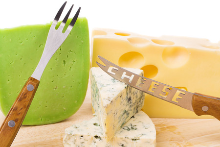 Delicious cheese and knife on wood platter. Whole background.の写真素材