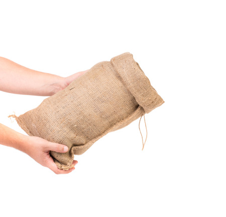 Hand holds bag with euro banknotes. Isolated on a white background.の写真素材