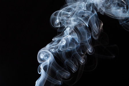 White smoke on black background. To be used as background.の写真素材