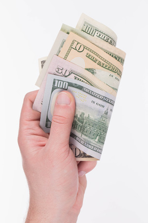 Hand holding dollar banknotes. Isolated on a white background.の写真素材
