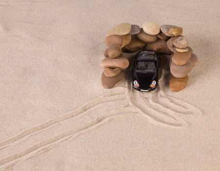 Concept of black racing car on the sand. Close up.の写真素材