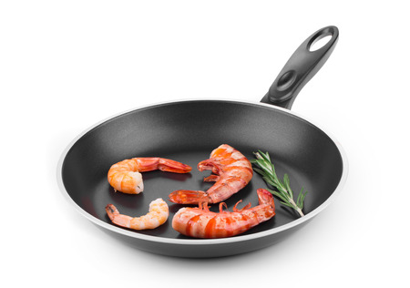 Raw shrimps on pan. Isolated on a white background.の写真素材