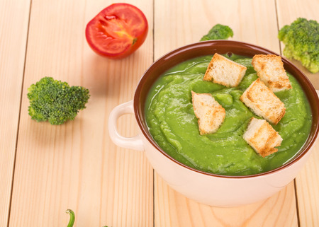 Cream soup with dried crusts isolated on wooden backgroundの写真素材