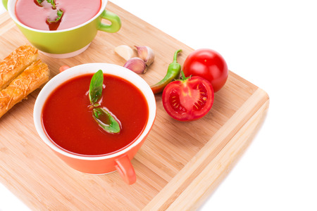Bowl of tomato soup on wood platter. Whole background.の写真素材