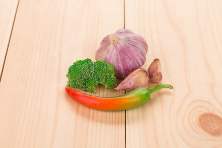 Composition of pepper and garlic. Whole wood background.の写真素材