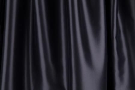 Black silk drapery. Isolated as a whole background.の写真素材