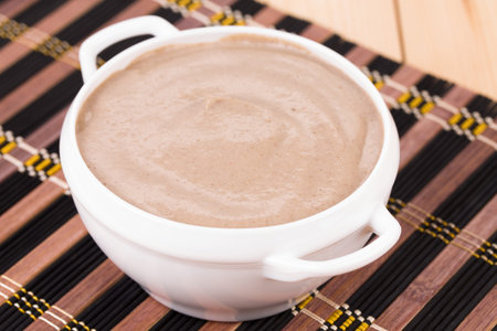 Close up of creamy mushroom soup. Whole background.