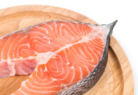 Salmon steak on platter. Close up located on the white background.の写真素材