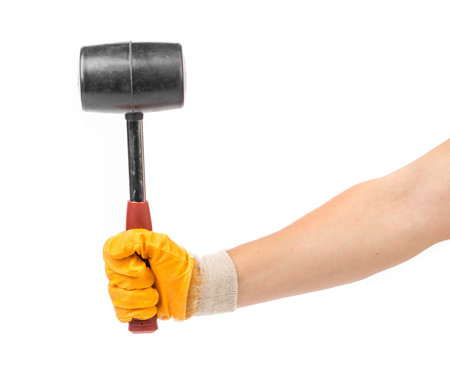Hand holding black hammer. Isolated on a white background.