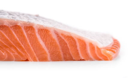 Fresh uncooked fish fillet texture. Isolated on a white background.の写真素材