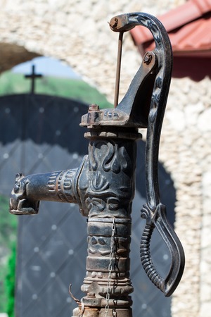 old rusted water pump outside in the parkの写真素材