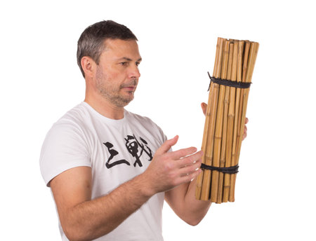 Man throw bunch of bamboo. Isolated on a white background.の写真素材