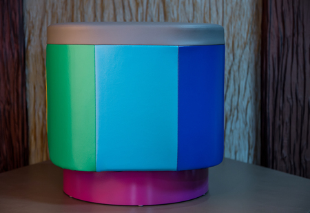Contemporary leather round pouffe with multicoloured stripesの写真素材