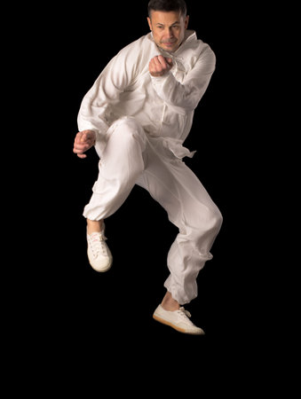 Karate fighters. Training fight. Located on the black background.