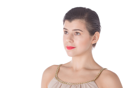 Smiling woman with big red lips and hazel eyes and clean skin looking aside isolated on white backgroundの写真素材