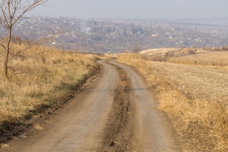 A hilltop view with a country track leading to a villageの写真素材