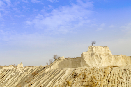 A sandy hill against blue sky in beautiful wildernessの写真素材