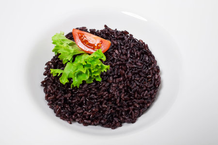 Black rice risotto with tomato. As a whole background.の写真素材