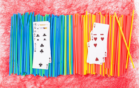 Plastic various drinking straws. Located on a red background.