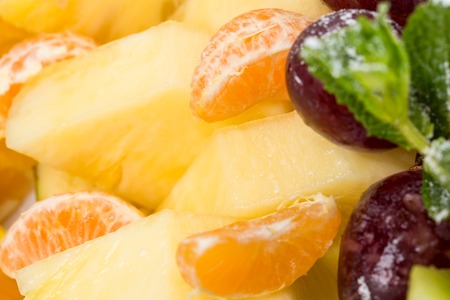 Sliced orange and pineapple on a fruit platter. Macro. Can be used as a  whole background.の写真素材