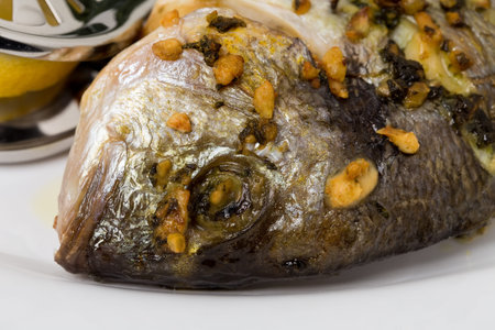 Grilled sea bass with spinach garnish. Can be used as a whole background.