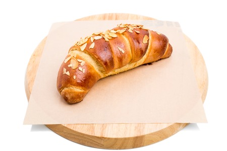 Delicious croissant with grated almonds. Isolated on a white background.の写真素材